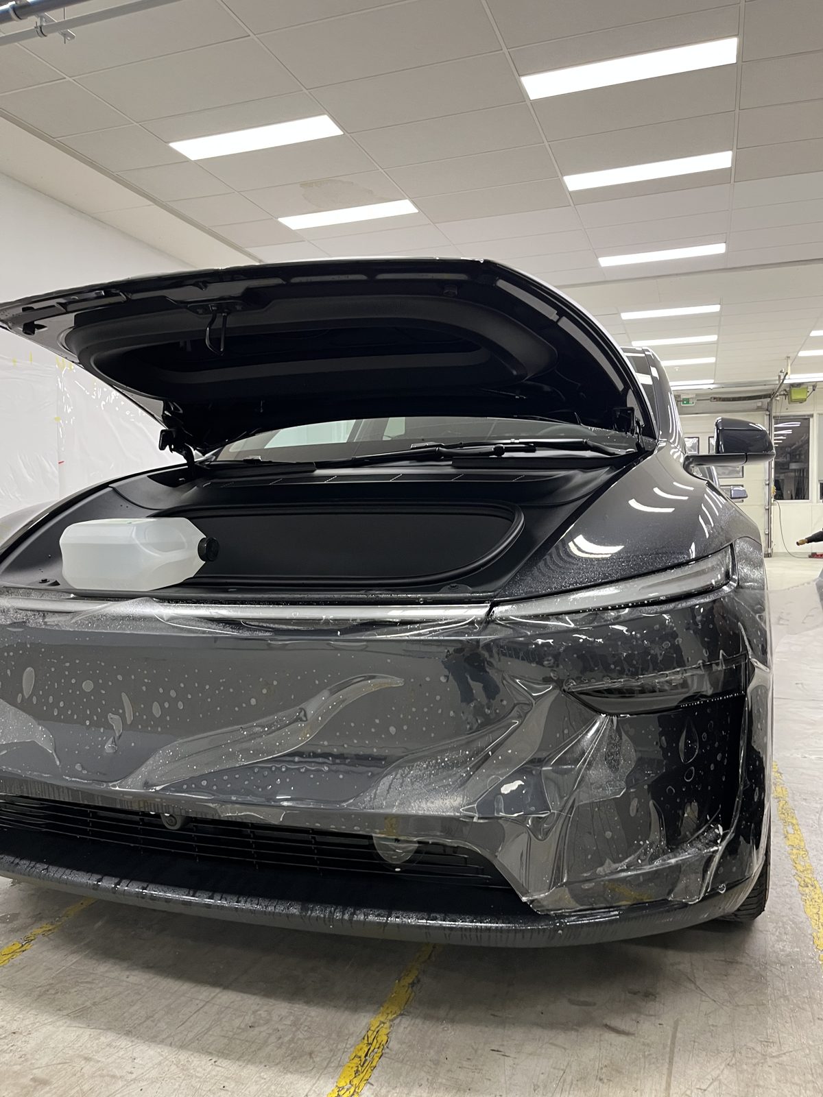 SUV with frunk open during ceramic wrap installation