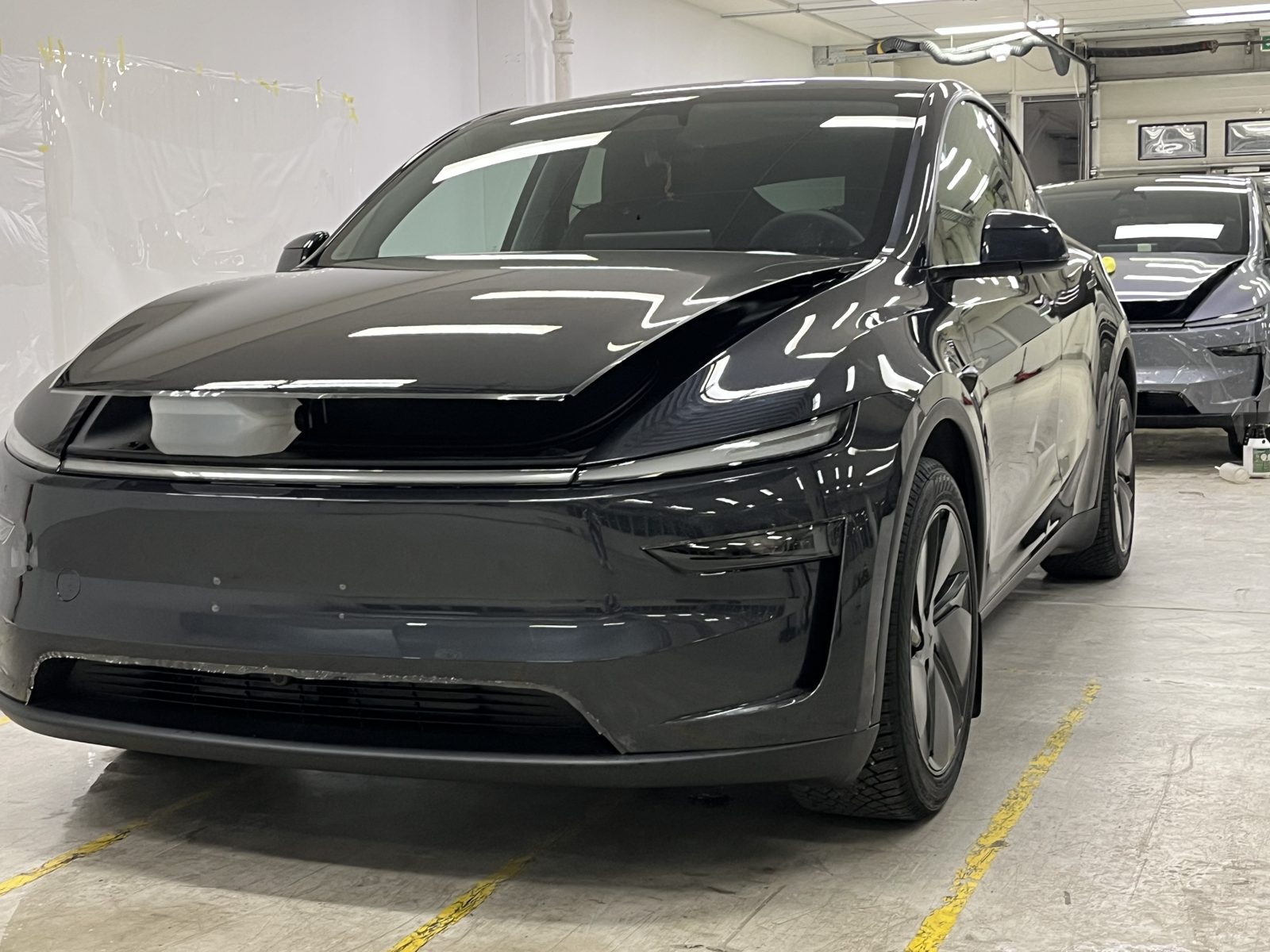Three-quarter view of a dark gray SUV after ceramic wrap