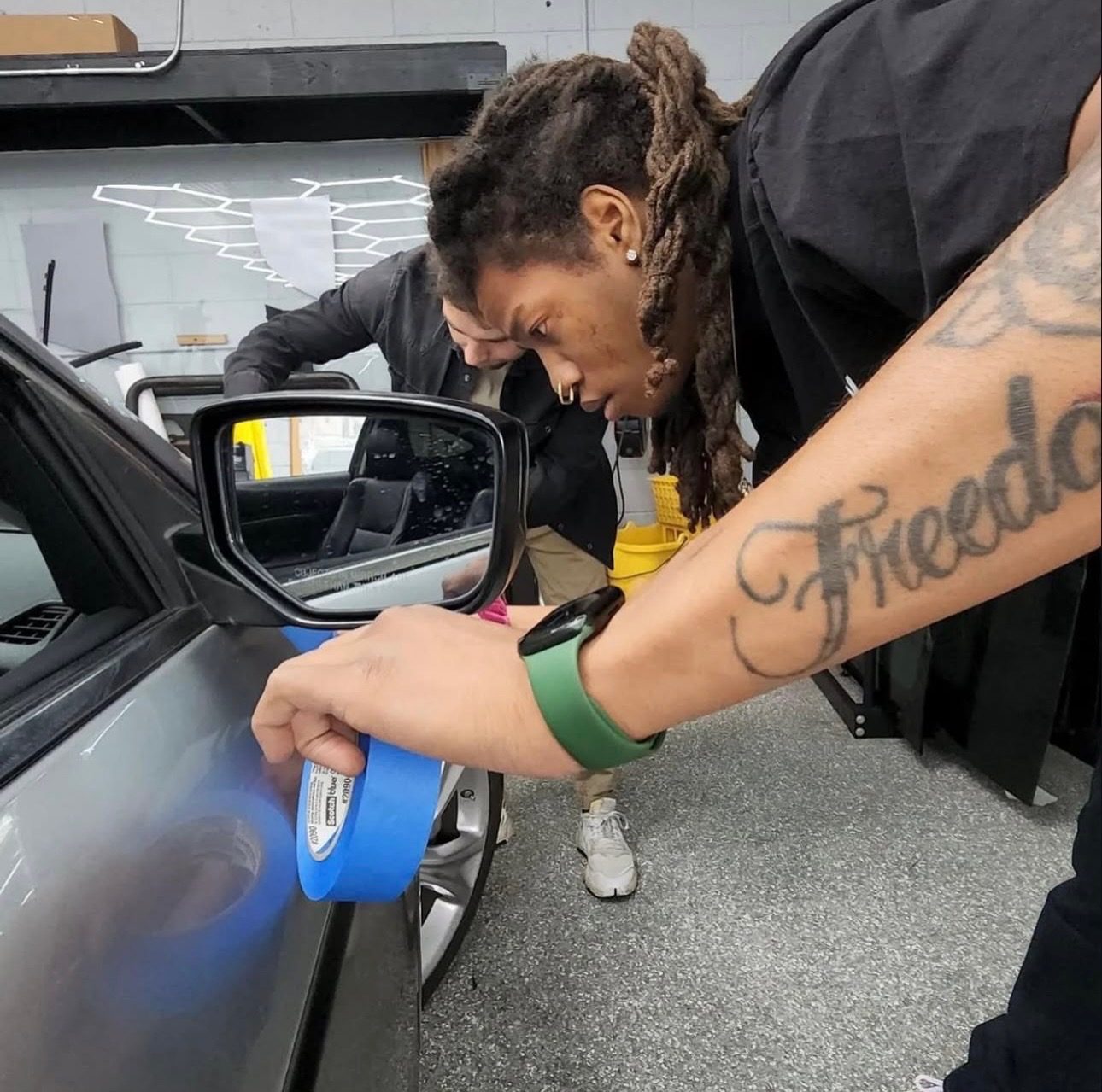 Masking around a side mirror before wrapping